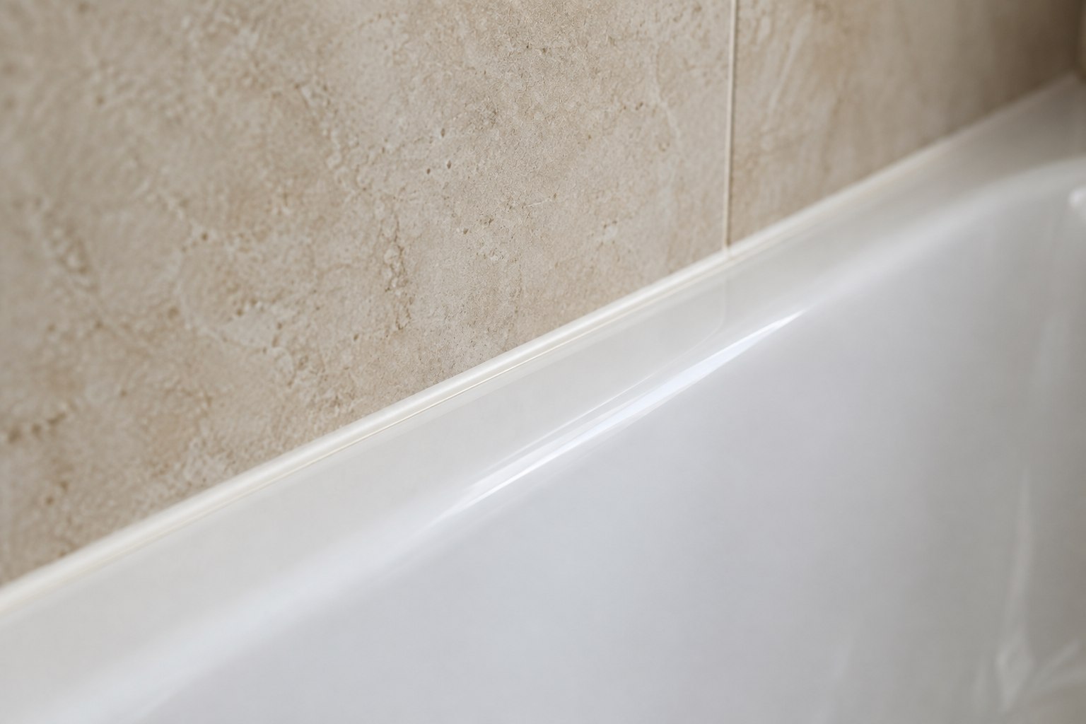 AI-generated close-up of a smooth silicone seal between a white bath rim and a tiled wall